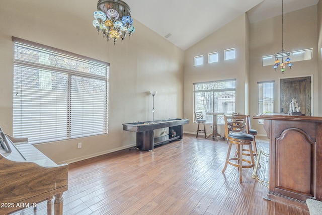 4864 E Eden Dr, Cave Creek, AZ 85331 - interior space featuring baseboards, high vaulted ceiling, an inviting chandelier, and light wood-style floors