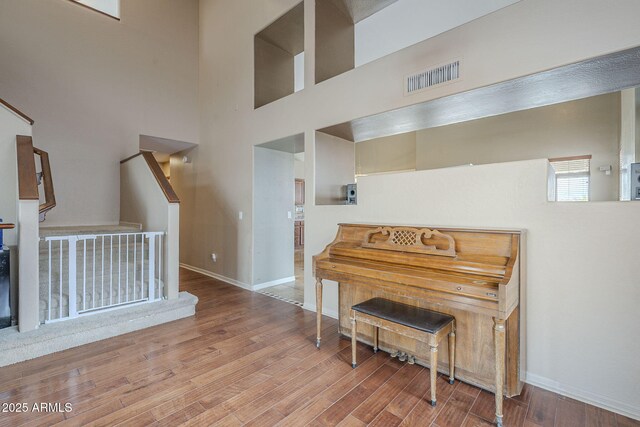 4864 E Eden Dr, Cave Creek, AZ 85331 - living area featuring wood finished floors, a towering ceiling, baseboards, and visible vents