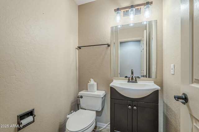 4864 E Eden Dr, Cave Creek, AZ 85331 - half bathroom with a textured wall, toilet, and vanity