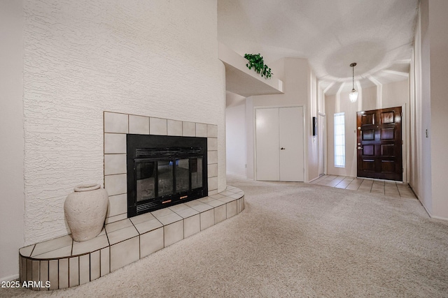 carpeted entrance foyer featuring a fireplace