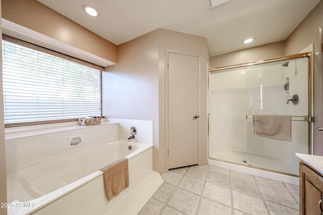 bathroom featuring vanity, recessed lighting, a stall shower, a garden tub, and tile patterned floors