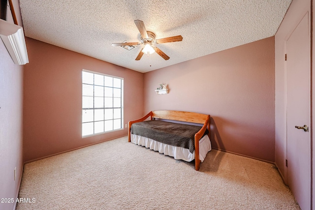 bedroom with carpet flooring, a textured ceiling, and ceiling fan