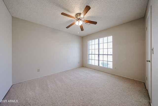 carpeted empty room with a textured ceiling and a ceiling fan