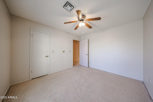 unfurnished bedroom with ceiling fan, visible vents, and a textured ceiling