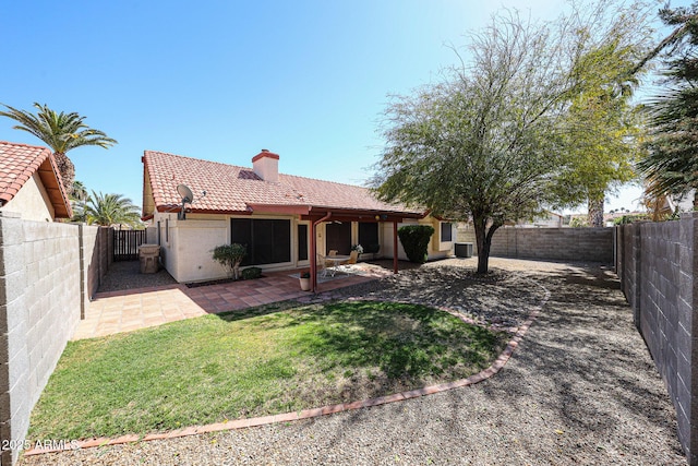 back of house with a patio area, stucco siding, a tiled roof, and a fenced backyard