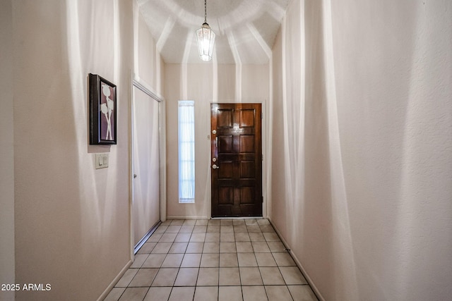 entryway featuring baseboards and light tile patterned flooring