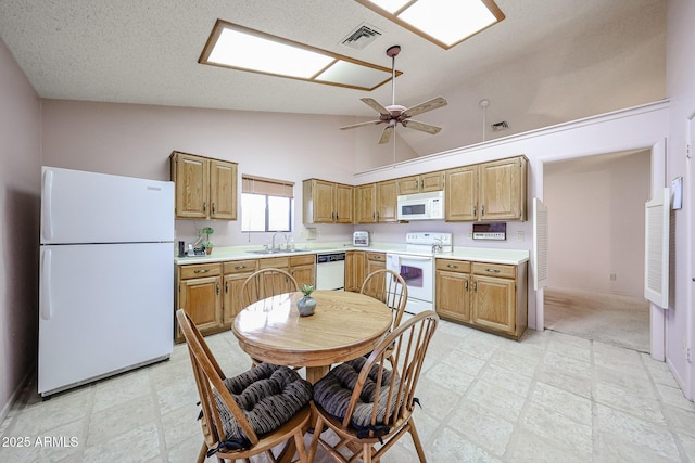 kitchen with white appliances, light floors, visible vents, and light countertops