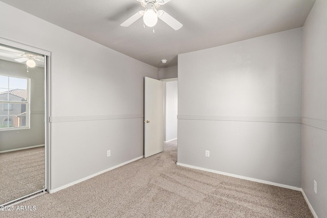 unfurnished bedroom featuring a closet, baseboards, a ceiling fan, and carpet floors