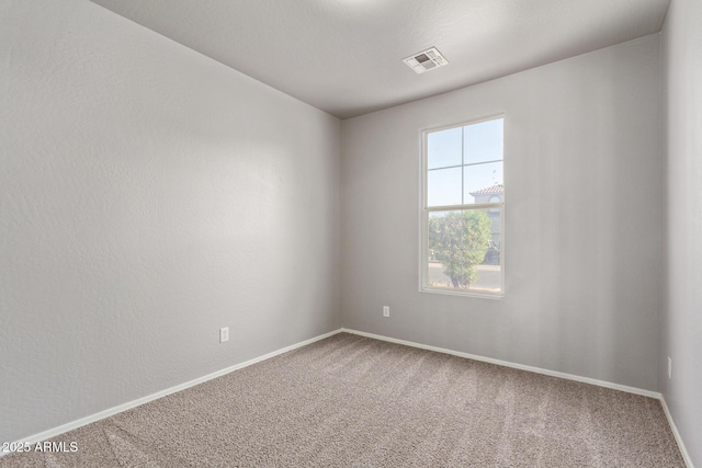 unfurnished room featuring baseboards, visible vents, and carpet floors