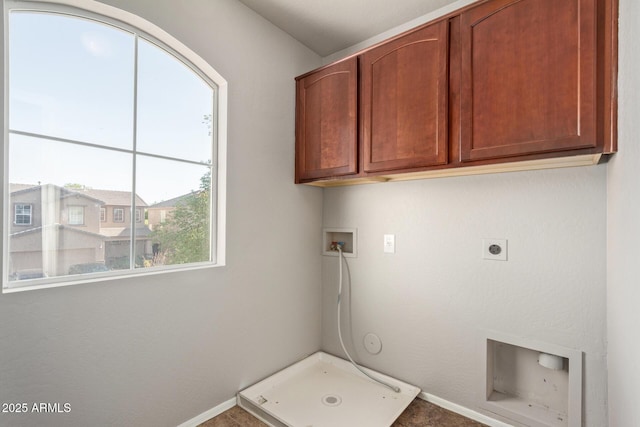 clothes washing area featuring hookup for a washing machine, electric dryer hookup, cabinet space, and baseboards