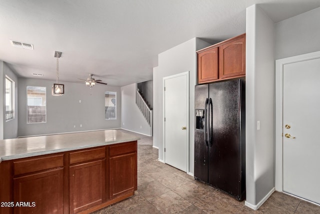 kitchen with visible vents, ceiling fan, black fridge with ice dispenser, and light countertops