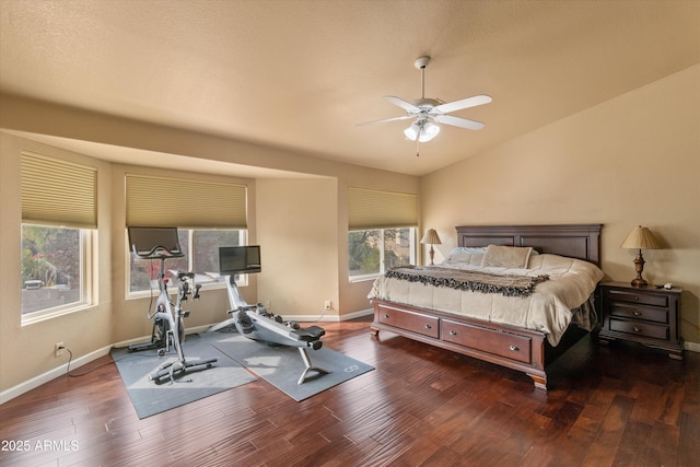 bedroom featuring lofted ceiling, wood finished floors, and baseboards