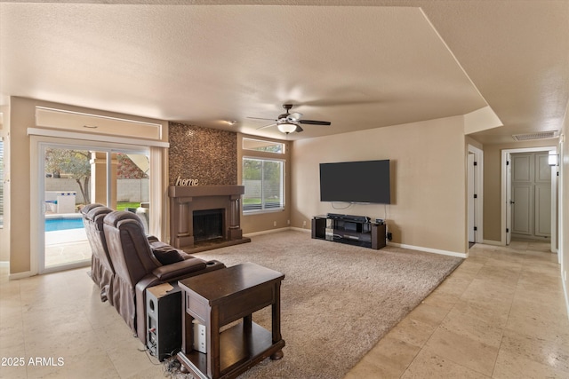 living room featuring light carpet, visible vents, a ceiling fan, a textured ceiling, and a fireplace