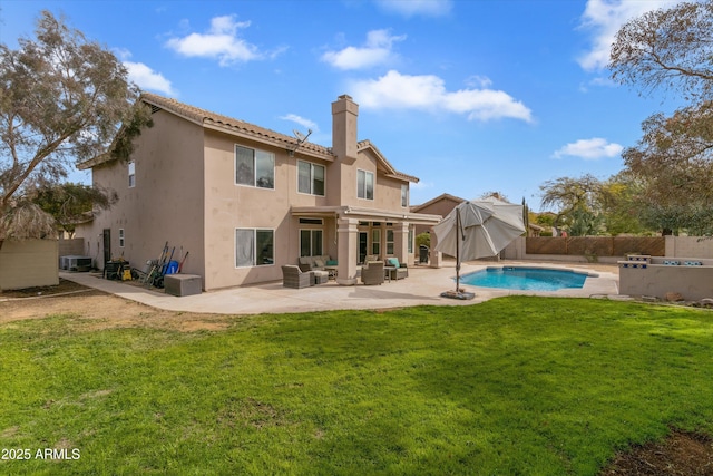 back of property featuring a patio, a fenced backyard, an outdoor hangout area, a yard, and stucco siding