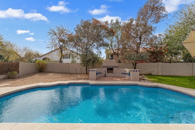 view of pool with a fenced in pool, a fenced backyard, and an outdoor fireplace