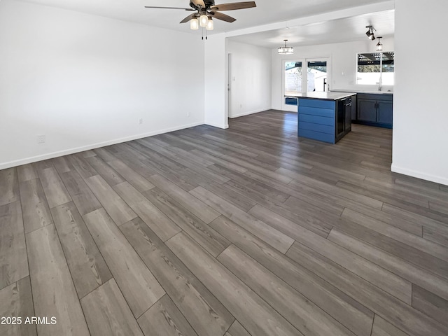 unfurnished living room with ceiling fan and light wood-type flooring