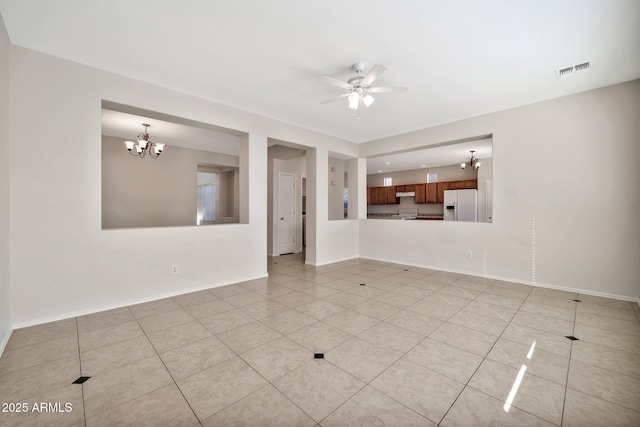 spare room with light tile patterned floors, baseboards, visible vents, and ceiling fan with notable chandelier