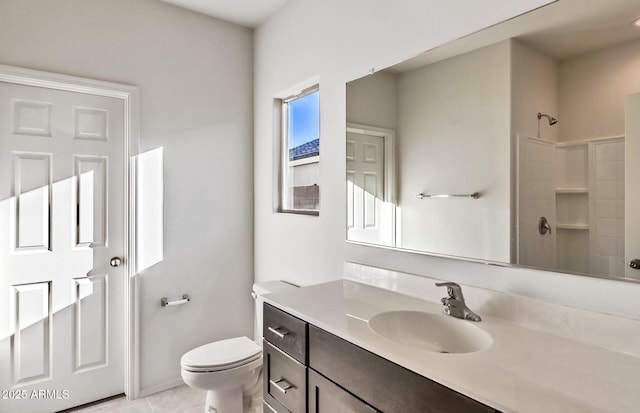 bathroom with walk in shower, toilet, vanity, a wealth of natural light, and tile patterned flooring