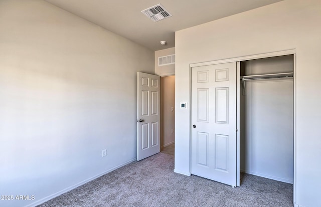 unfurnished bedroom with carpet and a closet