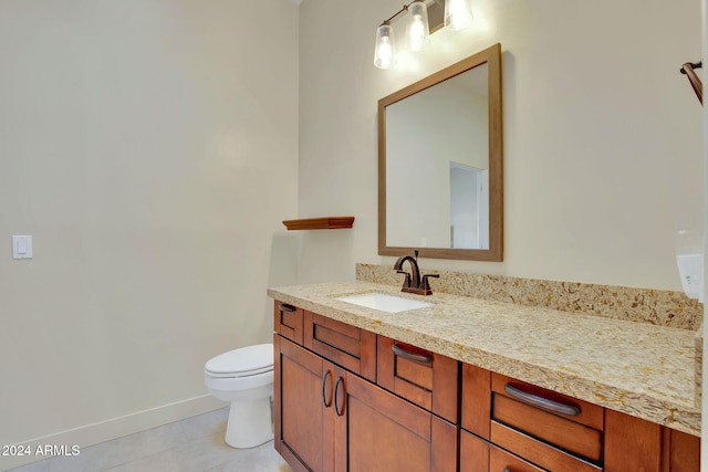 bathroom featuring tile patterned flooring, vanity, and toilet