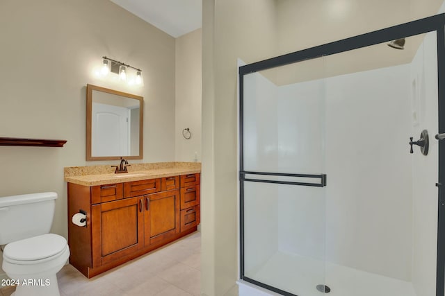 bathroom featuring tile patterned floors, toilet, vanity, and walk in shower