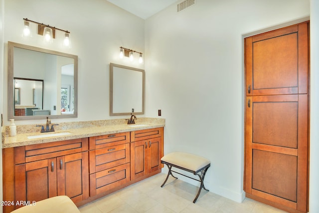 bathroom with tile patterned flooring and vanity