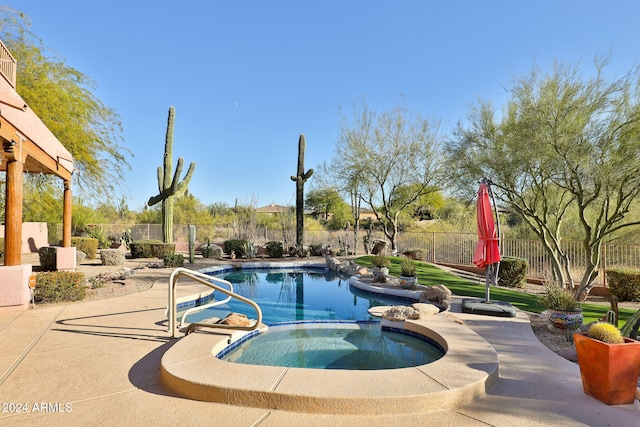 view of swimming pool with a patio area and an in ground hot tub