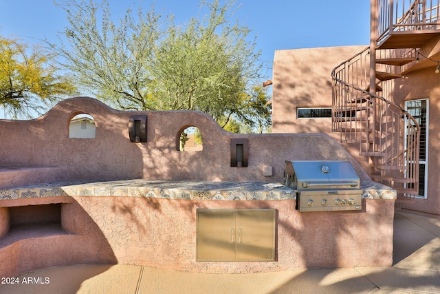 view of patio featuring a grill and an outdoor kitchen