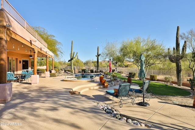 view of patio featuring a fenced in pool and ceiling fan