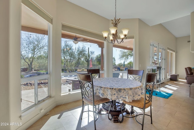 dining space featuring light tile patterned floors and ceiling fan with notable chandelier