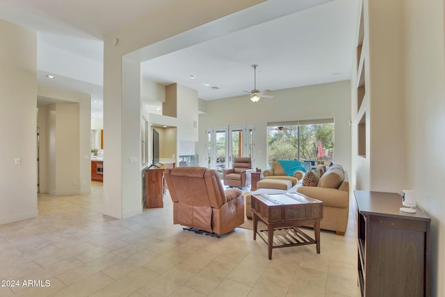 living room with ceiling fan and light tile patterned floors