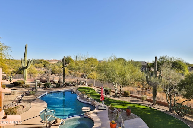 view of swimming pool featuring an in ground hot tub