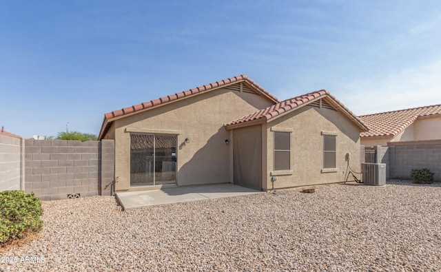 rear view of house featuring cooling unit and a patio area