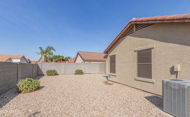 view of yard with a patio area and central air condition unit