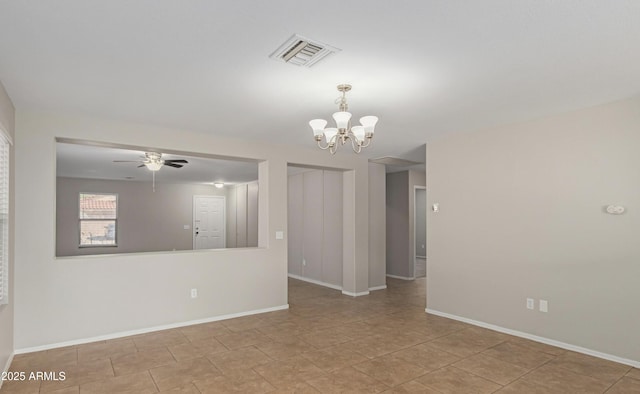 spare room with ceiling fan with notable chandelier