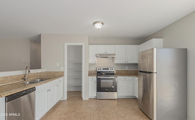 kitchen featuring sink, light tile patterned floors, white cabinetry, stainless steel appliances, and light stone countertops