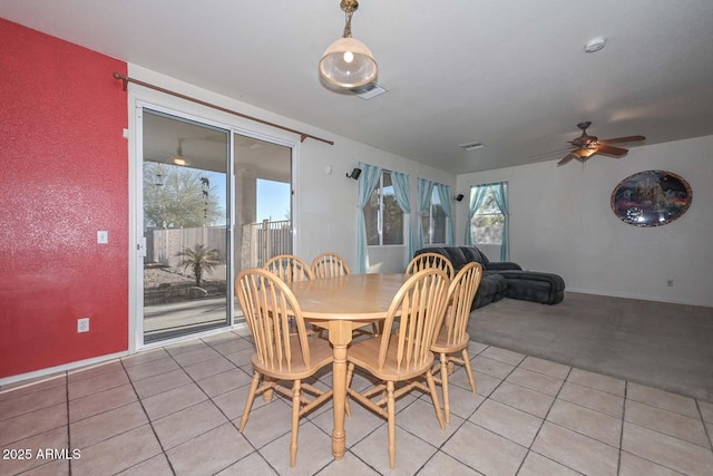 tiled dining area featuring ceiling fan