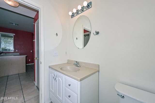 bathroom featuring tile patterned floors, vanity, and toilet