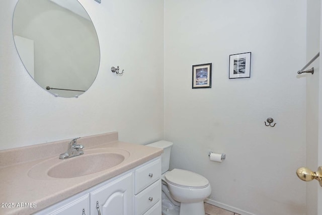 bathroom featuring toilet, vanity, and tile patterned flooring