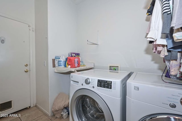 washroom featuring separate washer and dryer and light tile patterned flooring