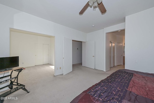 carpeted bedroom featuring ceiling fan and a closet