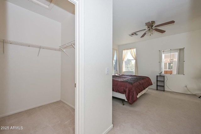 bedroom featuring light carpet, ceiling fan, and a closet