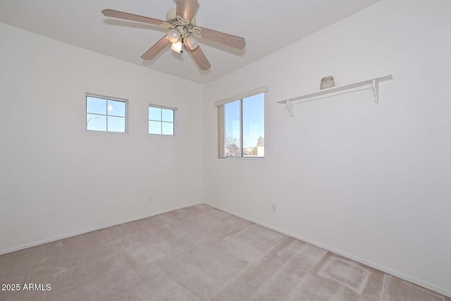 empty room featuring light carpet and ceiling fan