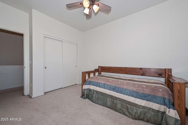 carpeted bedroom featuring ceiling fan and a closet