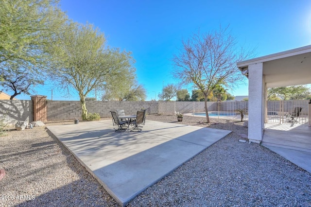 view of patio / terrace with a fenced in pool