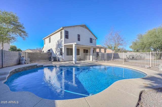 view of pool with central AC unit and a patio