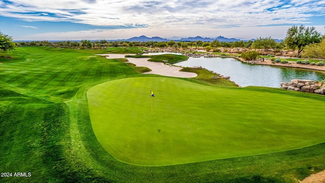 surrounding community with a water and mountain view