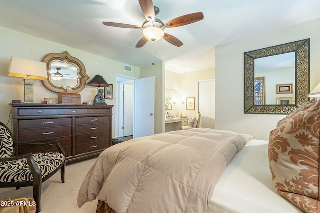 carpeted bedroom with a ceiling fan and visible vents