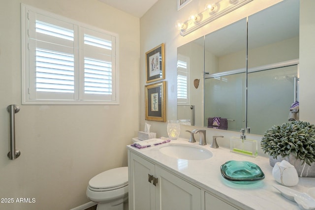 full bathroom featuring a shower with door, a healthy amount of sunlight, vanity, and toilet