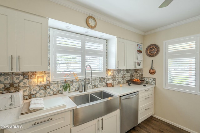 kitchen featuring a sink, light countertops, dishwasher, crown molding, and backsplash